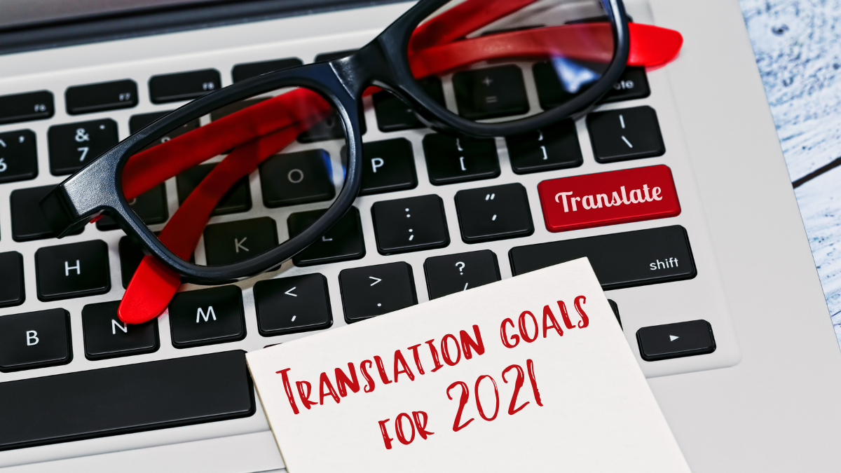 Computer keyboard and a note pad with the text Translation goals for 2021